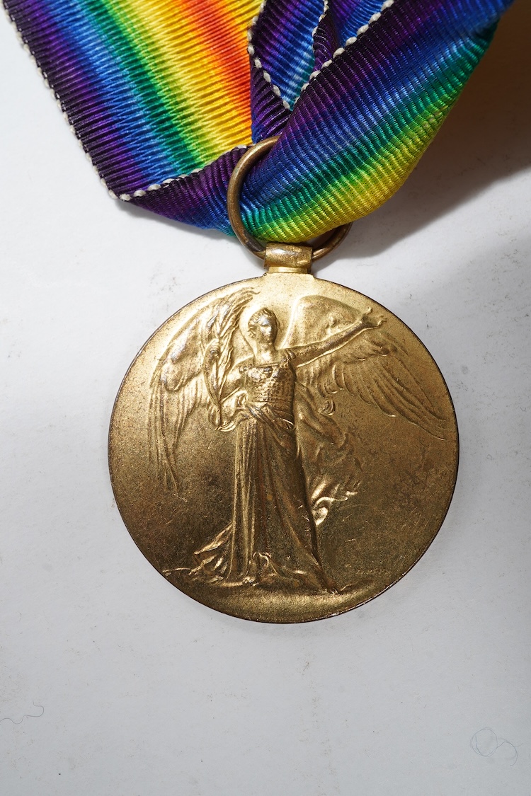 A First World War medal trio awarded to 2140 SJT. G. Watson. Argyll and Sutherland Highlanders, together with the related cap badge and two photographs of Watson in Highlanders uniform and printed as postcards